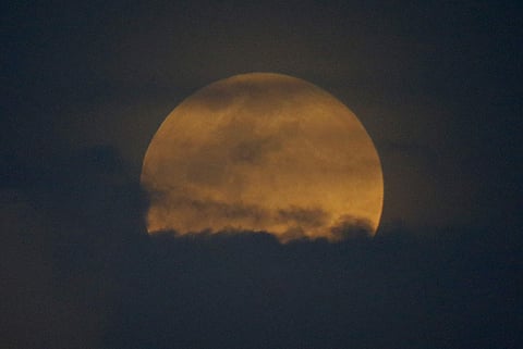 The moon rises in a rare phenomena that combines a supermoon, a Blue Moon and a total lunar eclipse as seen in Philippines | AP