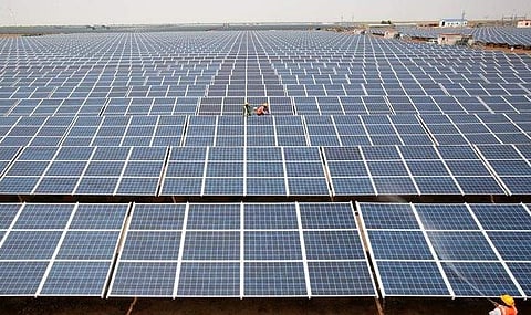 Workers install photovoltaic solar panels. (Photo | Reuters)