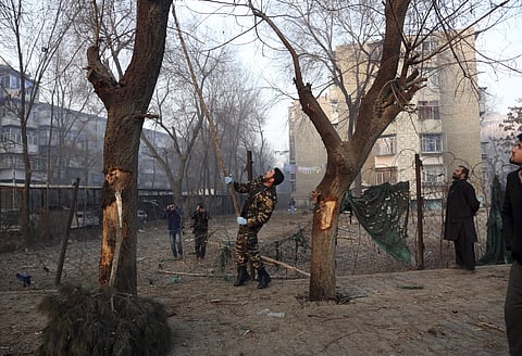 Afghan security forces inspect the scene of the suicide attack in Kabul, Afghanistan. (AP)