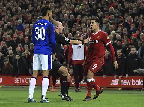 Tempers flare between Everton's Mason Holgate, left, and Liverpool's Roberto Firmino during the English FA Cup Third Round soccer match between Liverpool and Everton at Anfield in Liverpool, England, Friday, Jan. 5, 2018. | AP