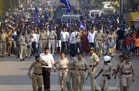 Mumbai Policemen accompany the Dalits protestors as they stage a protest against the violence in Bhima Koregaon area of Pune in Mumbai on Tuesday. (Photo | PTI)