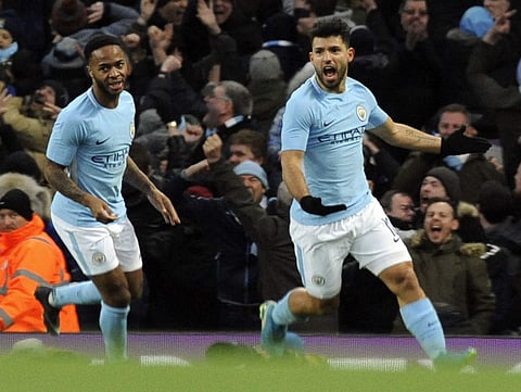 Manchester City's Sergio Aguero, right, celebrates after scoring his side's first goal during the English FA Cup Third Round soccer match against Burnley. | AP