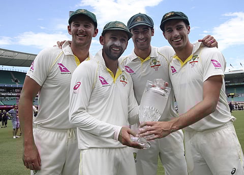 Australian bowlers Josh Hazlewood, Nathan Lyon, Mitchell Starc, and Pat Cummins hold the Ashes trophy as they celebrate the series triumph | AP