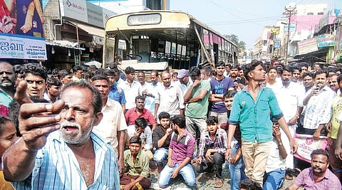 Public and CITU members protesting in front of a bus that was vandalised after an accident at Virudhachalam in Cuddalore; the spot at Santhome in the city,