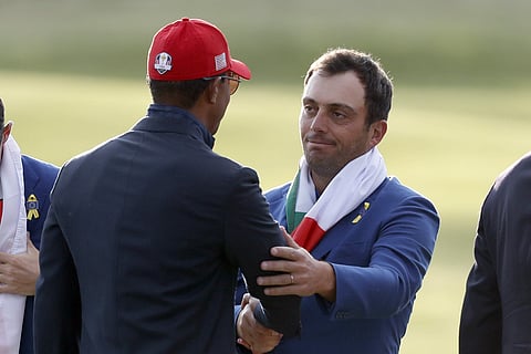 Europe's Francesco Molinari, right, is congratulated by Tiger Woods of the US during the trophy ceremony after the European team won the 2018 Ryder Cup golf tournament at Le Golf National in Saint Quentin-en-Yvelines. | AP