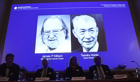 The Nobel prize laureate in medicine or physiology 2018 is shown on the screen James P Allison, left, and Tasuku Honjo, during the presentation at the Karolinska Institute in Stockholm. ( Photo | AP)