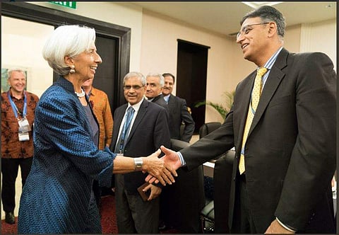 IMF chief Christine Lagarde shankes hand with Pakistan Finance Minister Asad Umar during Fund's annual meeting in Bal.( Photo | twitter@IMFNews)