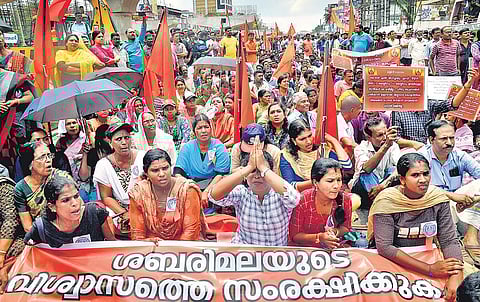Members of Sabarimala Samrakshana Samithi staging a protest by blocking Vyttila Junction against the Supreme Court verdict on Sabarimala in Kochi on Tuesday (Photo | EPS)