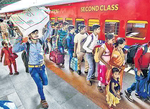 Migrant workers from Uttar Pradesh and Bihar board a train at Ahmedabad station  to go back to their home states in the wake of attacks on them in Gujarat | PTI