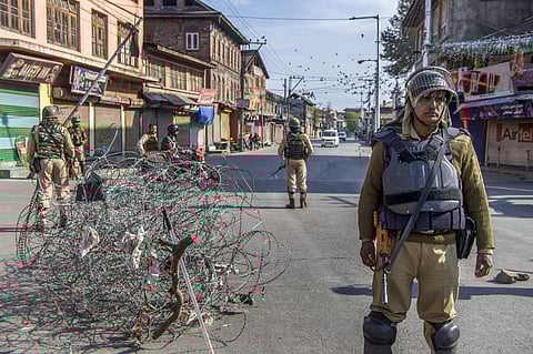 Security personnel stands guard during restrictions and strike called by separatists after the killing of PhD scholar-turned-Hizbul Mujahideen commander Manaan Bashir Wani. (Photo| PTI)