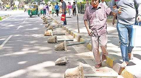 Blocks of concrete attached to iron poles placed along the road to prevent parking of vehicles  | Nagaraja Gadekal