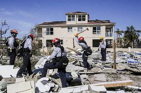 Members from South Florida Task Force search a flattened home destroyed by Hurricane Michael in Mexico Beach, Florida | AP