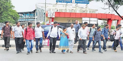 File image of commuters crossing the road at Baiyappanahalli station