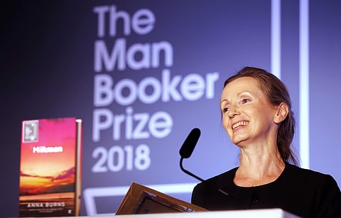 Writer Anna Burns smiles after she was presented with the Man Booker Prize for Fiction 2018 by Britain's Camilla, the Duchess of Cornwall during the prize's 50th year at the Guildhall in London, Tuesday. (Photo | Associated Press)