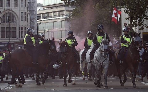 Mounted police horses react to a flare going off during an anti-fascist demonstration held in protest against a rival march by the Football Lads Alliance march, London | AP