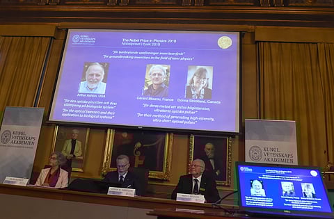 The Nobel Prize laureates for physics 2018 shown on the screen from left, Arthur Ashkin of the United States, Gerard Mourou of France and Donna Strickland of Canada during the announcement at the Royal Swedish Academy of Sciences in Stockholm, Sweden. ( P