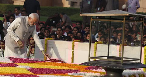 Prime minister Narendra Modi pays tributes at Mahatma Gandhi's memorial in Raj Ghat on his 149th birth anniversary in New Delhi on Tuesday. | (Shekhar Yadav | EPS)