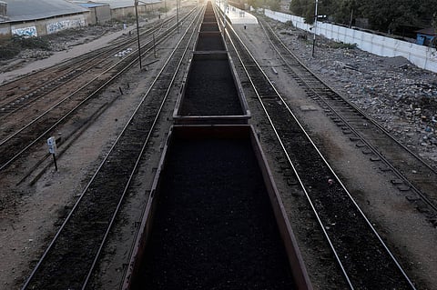 A cargo train loaded with coal dust, moves past the port area near City Station in Karachi, Pakistan. (Photo | Reuters)