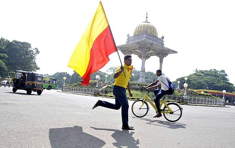 A Kannada activist seen running with the Karnataka flag on the occasion of Karnataka Rajyotsava in Mysuru on Wednesday. (File Photo | EPS/Udayashankar S)