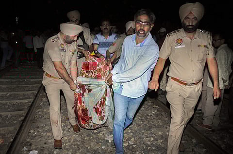 Amritsar Police and volunteers carry a victim from the site of a train accident at Joda Phatak in Amritsar on Friday, October 19, 2018.(PTI)