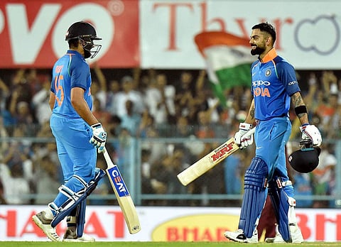 Virat Kohli celebrates his century with teammate Rohit Sharma during the first One Day International cricket match against West Indies at ACA Cricket Stadium Barsapara in Guwahati, Oct 21 2018. (Photo | PTI)