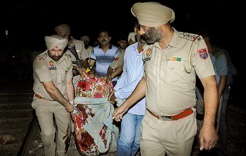 Amritsar Police and volunteers carry a victim from the site of a train accident in Amritsar (File | PTI)