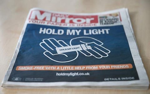 The front of a four page wraparound advertisement by Philip Morris calling on people to quit smoking for 30 days is seen on the front page of the daily Mirror in London, Britain, October 22, 2018. (Photo: Reuters)