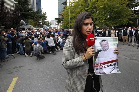 A journalist holding a poster of missing Saudi writer Jamal Khashoggi, speaks to camera near the Saudi Arabia consulate in Istanbul, Monday, Oct. 8, 2018. (Photo | AP)