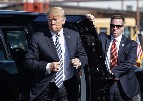 President Donald Trump steps from his motorcade vehicle before boarding Air Force One at Elko Regional Airport, Saturday, Oct. 20, 2018, in Elko, Nev., after a campaign rally. | AP