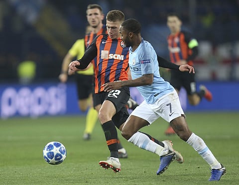 Manchester City Raheem Sterling, right, and Shakhtar Mykola Matviyenko challenge for the ball during the Group F Champions League soccer match between FC Shakhtar Donetsk and Manchester City at the Metalist Stadium in Kharkiv, Ukraine, Tuesday, Oct. 23, 2