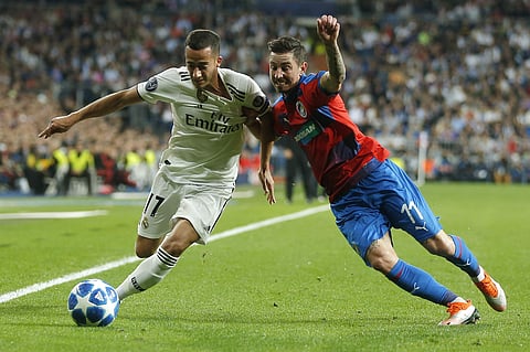 Real forward Lucas Vazquez, left, challenges for the ball with Plzen's Milan Petrzela during the Champions League, group G, soccer match between Real Madrid and Viktoria Plzen at the Santiago Bernabeu stadium in Madrid, Spain, Tuesday Oct. 23, 2018. | AP
