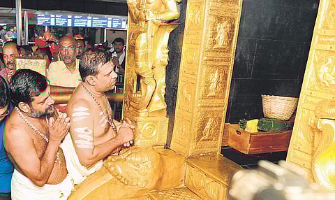 Newly appointed Sabarimala melsanthi V N Vasudevan Namboothiri and Malikappuram melsanthi M M Narayanan Namboothiri pray in front of the sanctum sanctorum of Sabarimala Lord Ayyappa temple on Sunday  | Express