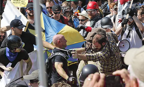 White nationalist demonstrators clash with counter demonstrators at the entrance to Lee Park in Charlottesville. (Photo | AP)