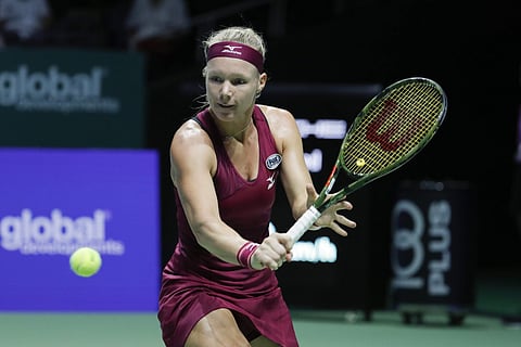 Kiki Bertens plays a return shot while competing against Naomi Osaka during their women's singles match at the WTA tennis finals in Singapore. | AP