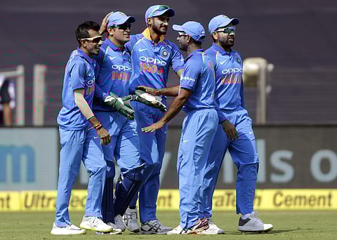 India's wicketkeeper Mahendra Singh Dhoni, second left, celebrates with teammates the dismissal of West Indies' batsman Chandrapaul Hemraj during the third one-day international cricket match between India and West Indies in Pune. (Photo | AP)