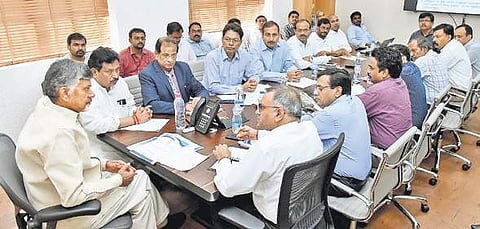 Chief Minister N Chandrababu Naidu with the inter-ministerial central team that toured cyclone Titli affected areas of Srikakulam district at Praja Vedika on Friday I Express