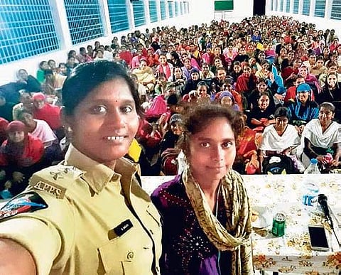 Tenali DSP M Snehita takes a selfie with a girl student during an awareness programme  at a college in Guntur district on Friday I Express