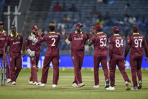 West Indies team players celebrate the dismissal of Indian batsman Yuzvendra Chahal during the 3rd ODI cricket match in Pune, Oct 27 2018. West Indies won the match by 43 runs. (Photo | PTI)