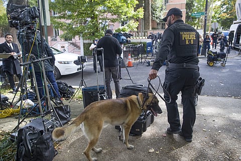 An officer with the Uniform Division of the United States Secret Service uses his dog to search a checkpoint near the home of President Barack Obama, Oct. 24, 2018, in Washington. (Photo | AP)