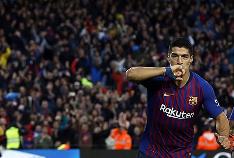 Barcelona forward Luis Suarez celebrates after scoring his side's third goal against Real Madrid | AP