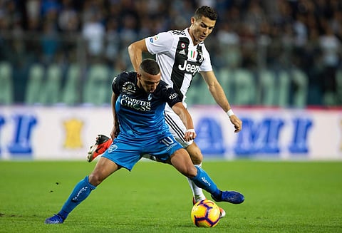 Juventus' Cristiano Ronaldo, right, challenges Empoli's Ismael Bennacer during the Serie A soccer match between Empoli and Juventus at the Carlo Castellani stadium in Empoli, Oct. 27, 2018. (Photo | AP)