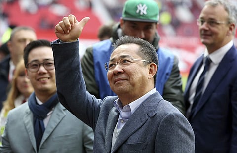 In a Jan. 5, 2016 photo, Leicester City Chairman Vichai Srivaddhanaprabha gestures to the crows at a soccer game in Manchester, England. | AP