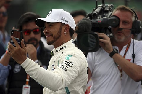 Mercedes driver Lewis Hamilton, of Britain, celebrates after becoming Formula One champion during the Mexico Grand Prix auto race at the Hermanos Rodriguez racetrack in Mexico City, Sunday, October 28, 2018. | AP