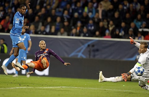 Hoffenheim goalkeeper Oliver Baumann, right, fails to save as Manchester City midfielder David Silva scores his side's second goal during the group F Champions League soccer match between Hoffenheim and Manchester City at the Rhein-Neckar-Arena stadium in