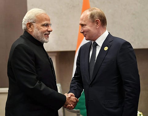 Prime Minister Narendra Modi shakes hands with Russian President Vladimir Putin.  (PIB Photo)
