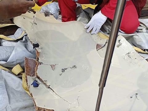In this photo released by Indonesian Disaster Mitigation Agency (BNPB) a rescuer inspects debris believed to be from Lion Air passenger jet that crashed off West Java on Monday, Oct. 29, 2018. (Photo | AP)