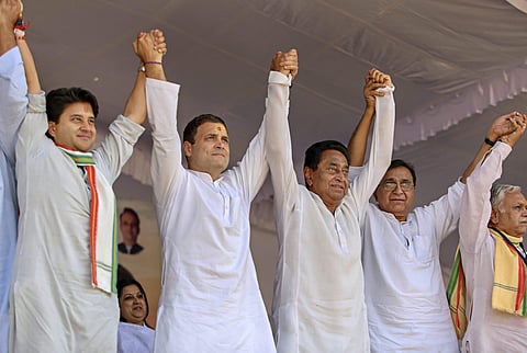 Congress President Rahul Gandhi flanked by Congress leaders Kamal Nath and Jyotiraditya Scindia during a public meeting at Dussehra Maidan in Ujjain Monday October 29. 2018. | PTI