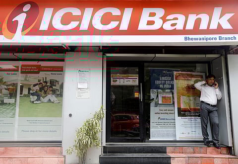 A man speaks on the phone outside an ICICI Bank branch in Kolkata. (Photo| Reuters)