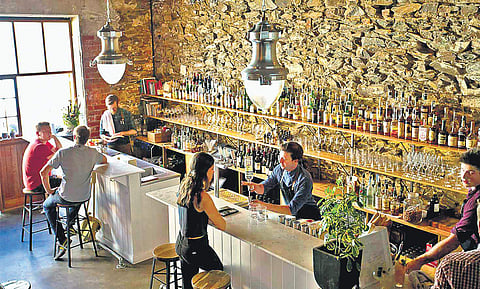 Clockwise from above: Bar tenders serving guests at Clever Little Tailor; people enjoying drink at Hains &Co