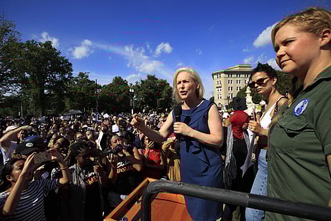 Sen. Kirsten Gillibrand, D-N.Y., with actress and comedian Amy Schumer, right, and actress model Emily Ratajkowski, center, speaks at a rally against Supreme Court nominee Brett Kavanaugh at the Supreme Court in Washington. (Photo: AP)